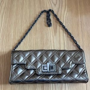 Like new. Sondra Roberta paten leather taupe colored purse.